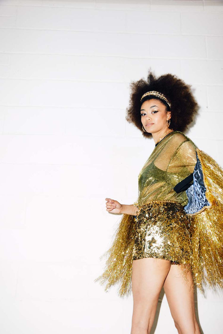 Woman wearing gold sequin shorts