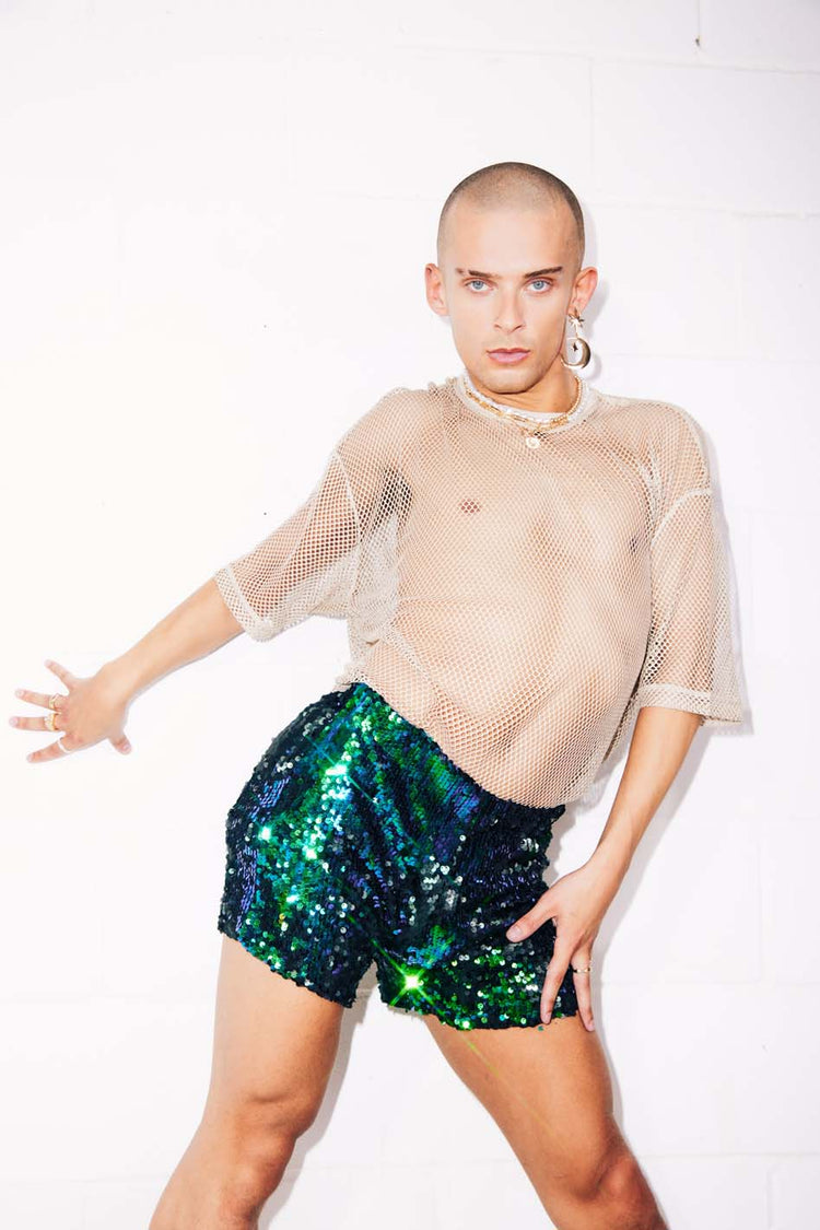 Man wearing green sequin shorts