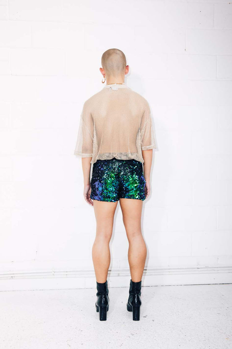 Man wearing green sequin shorts