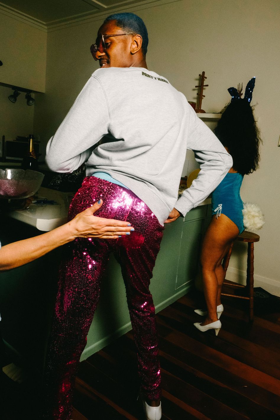 Man wearing pink sequin pants