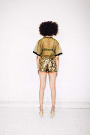 Woman wearing gold sequin shorts