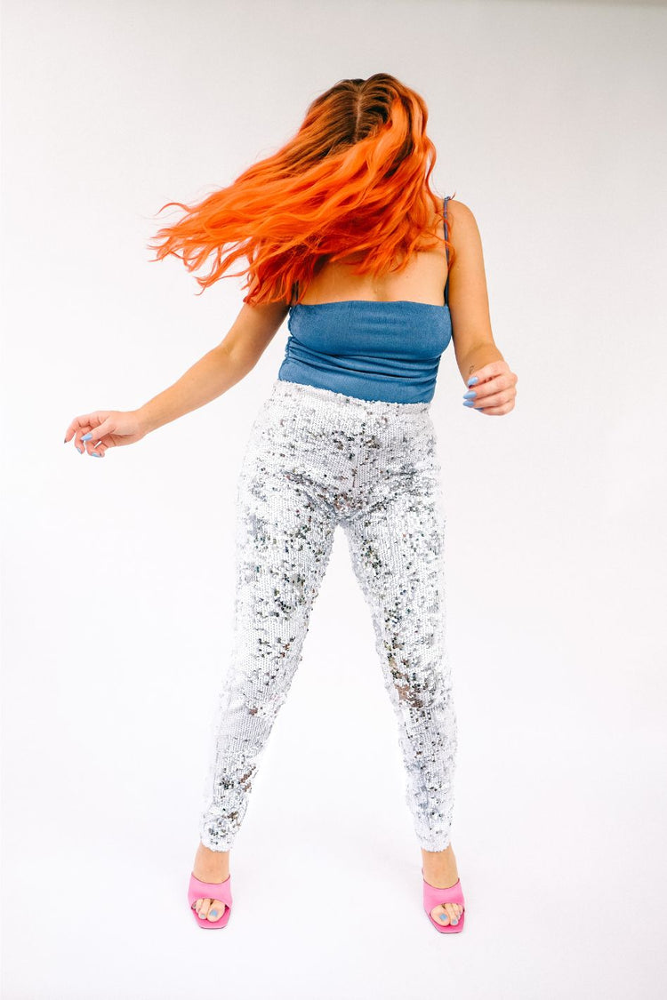 Women wearing white silver sequin pants